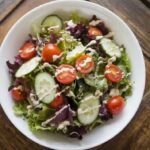 A vibrant bowl of house salad with fresh vegetables