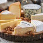 A rustic cheese board showcasing a selection of rennet-free cheeses.