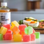 Colorful keto gummies displayed alongside apple cider vinegar and keto-friendly foods like avocado and eggs