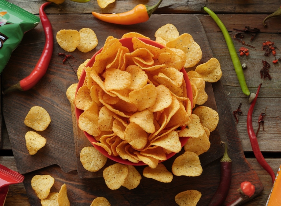 Variety of spicy chips with colorful packaging and chili peppers