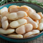 A detailed image showing a bowl of cooked lima beans with a smooth and creamy texture.