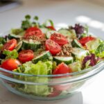 A bowl of salad sprinkled with Salad Supreme seasoning.